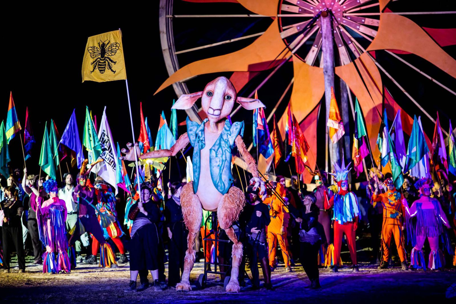 People dressed in colourful costumes parading through the grounds of Woodford Folk festivals in Queensland Australia